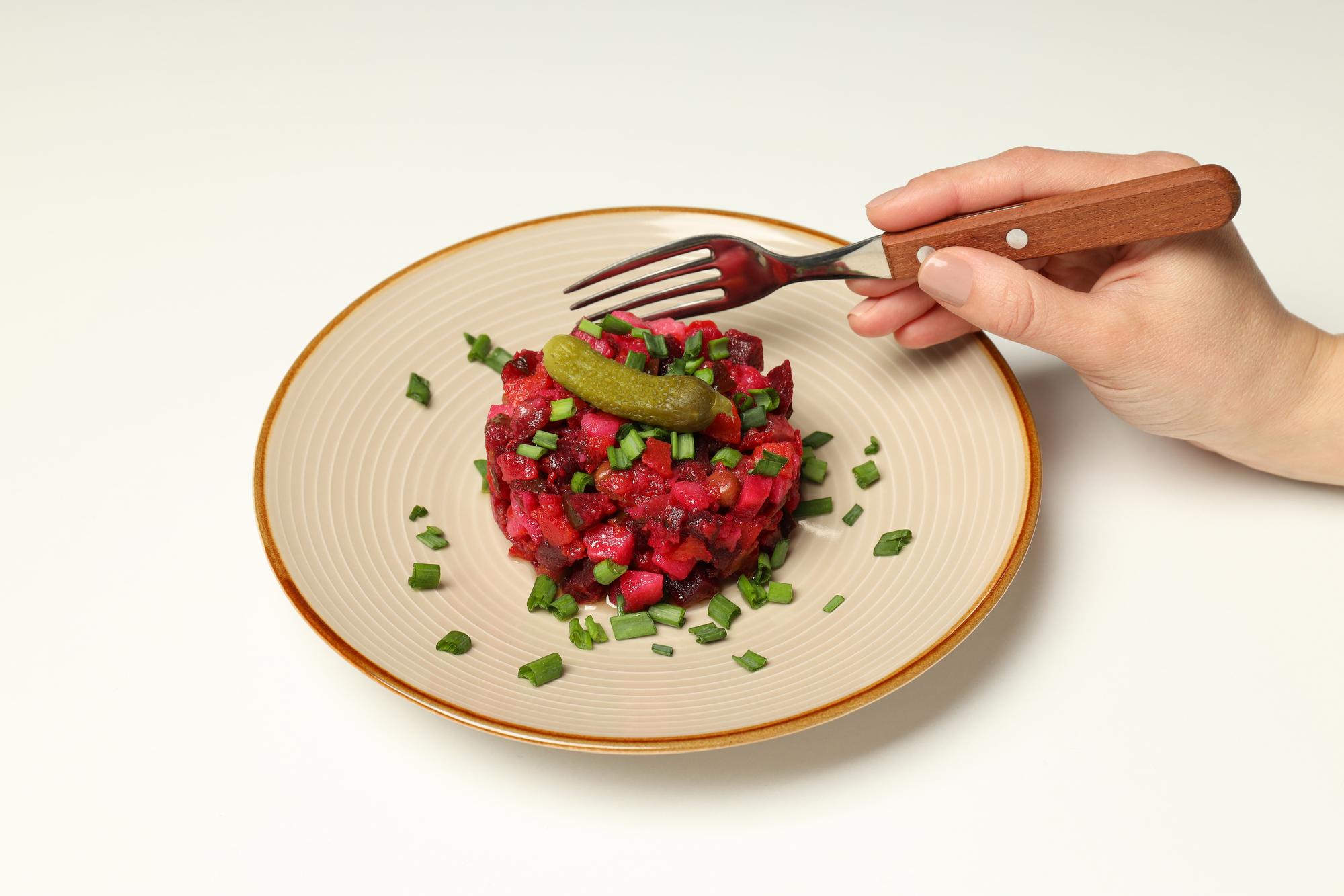 Hands plating a dish in studio